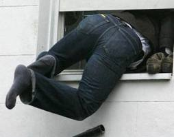 Man climbing out of window